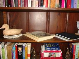 Carved duck and coffee table books