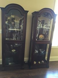 Pair of lighted display cabinets with glass shelves and cathedral style tops

