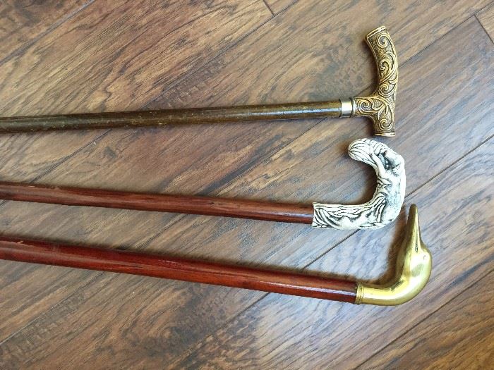 Walking canes with figural resin and brass handles
