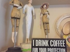 Ladies on a stick, I drink Coffee for your Protection sign
