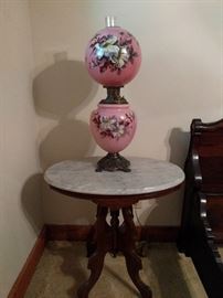 One of several marble-topped Victorian side tables and one of the 30 Gone with the Wind lamps in this house.