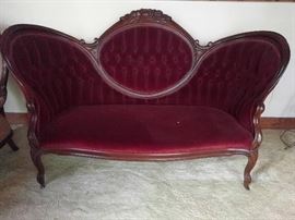 Bitchy looking Victorian red velvet couch.                         I think this one was rescued from the set of Bonanza, from one of their bordello episodes.                        
Where do you think "Miss Kitty" got her name?!?