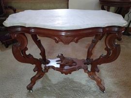 LOVE this Victorian marble-topped table! The beveled edge marble and carved dog on the wooden stretcher is excellent!