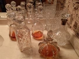 NICE collection of crystal decanters. They're all represented here: Baccarat, Waterford, Cartier, ABCG and a couple of good looking wannabes, one with an English sterling collar.