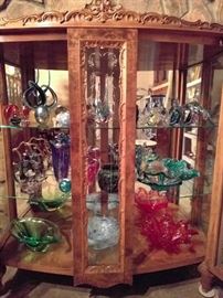 Wonderful burled walnut curio cabinet, filled with Murano glass, art glass and other sparkly objects that crows and raccoons cannot resist.