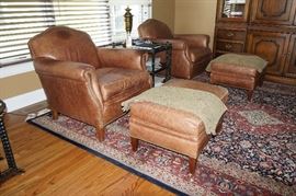 Pair modern, brown leather
armchairs with ottomans, marked
Century, Hickory, NC, $800/pair.