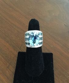 18k white gold with HUGE Aquamarine center stone surrounded by diamonds and smaller aquamarine stones. 