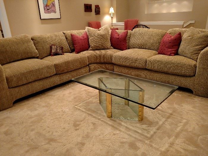 Preview sectional, glass and brass coffee table on room size rug