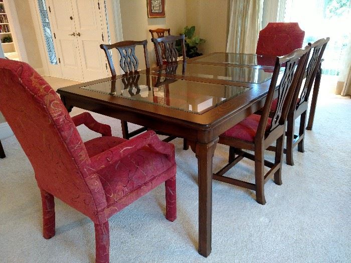 Oriental style glass and dark wood dining table , 4 feet wide by 7 feet long with one 24 inch leaf, another 24 inch leaf with table