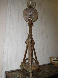 Antique brass oil lamp with religious figures on the base