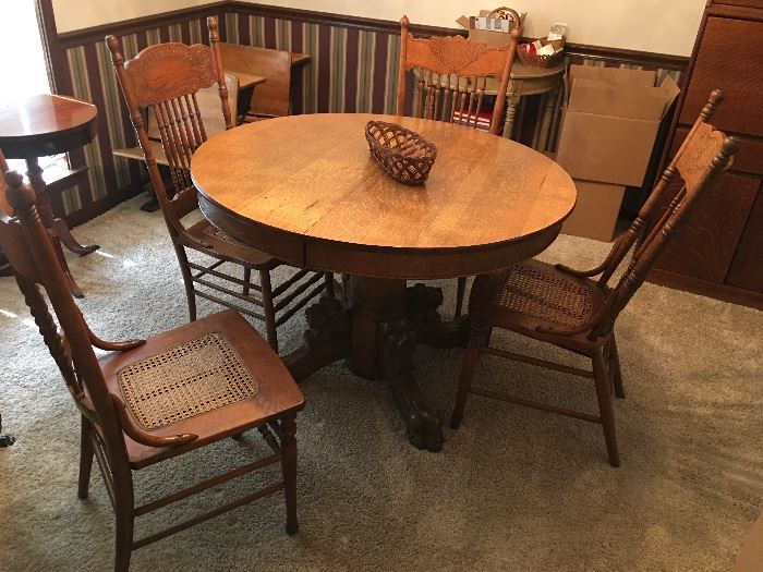 Oak dining set with claw feet and 4cane seated oak chairs