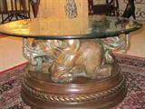 Oval glass top table with wood elephant base