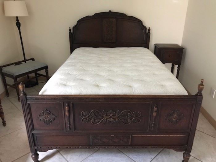 Antique bedroom set set with beautiful carving and detail.  the bed is shown with  a mattress and box spring, the matching side table and floor lamp with bench.  There is also a matching vanity.