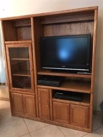 Oak entertainment unit.  Shown with TV and a few of the electronics at this sale