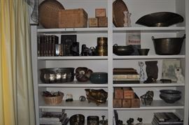 Baskets, brass antique grocer’s oval scoop for candy scale, brass bucket with bail handle antique, books, wooden antique cheese boxes, brass, vintage Minolta camera, Kodak No. 2 folding Brownie, Autographic antique camera, cat figurine, King Charles' spaniel, books