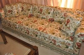 Floral sofa, brass square coffee table with glass top