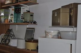 Kitchen cabinets from remodel, white storage cabinets, housewares that wouldn't fit in the packed kitchen, Malibu-type outdoor lighting
