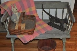 Primitive bench from Iowa, vintage pastel plaid wool blanket, hand stitched child's rabbit vintage, antique tattered children's book, old square splint basket with wooden handle, cast iron boot scraper in the form of a cat