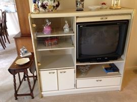 mid-century modern entertainment center with glass cupboard, closed cupboard and drawer
