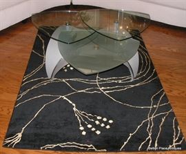 Three piece glass top coffee table measuring 42 inches wide, 16 tall........SOLD Floor rug still for sale...