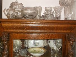 Cut glass and pressed glass w/lion heads on oak china cabinet