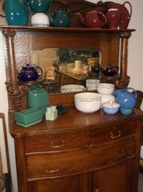 Oak sideboard w/Hall China teapots, pitchers, nesting bowld, etc.