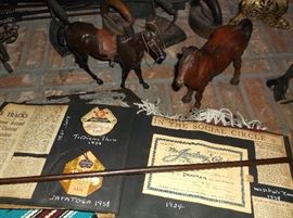 Jockey whip, scrapbook, and cast iron horses