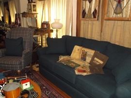 Sofa, wing back chair, and stained glass windows 