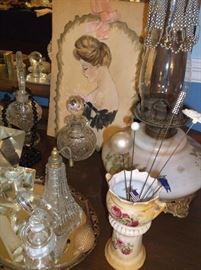Hat pins, oil lamp, and cut glass perfume bottles
