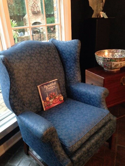 One of two blue wingback chairs