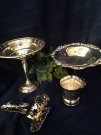 Some of the many sterling and silver plate serving pieces