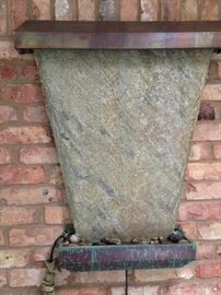 The hanging slate fountain provides soothing, enjoyable relaxation and was purchased in Santa Maria, California.