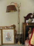 Heavy brass floor lamp with metal shade.