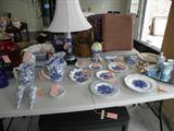Lots of blue and white decor items including a stick lamp.
