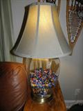 Glass bottom lamp filled with old marbles and shooters.  HEAVY.