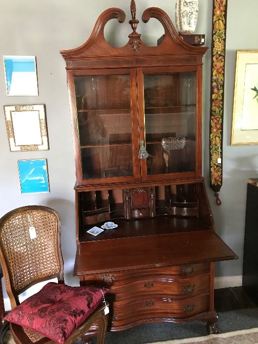  Early 20th century mahogany secretary, vintage frames, needlepoint bell pull, small caned side chair 