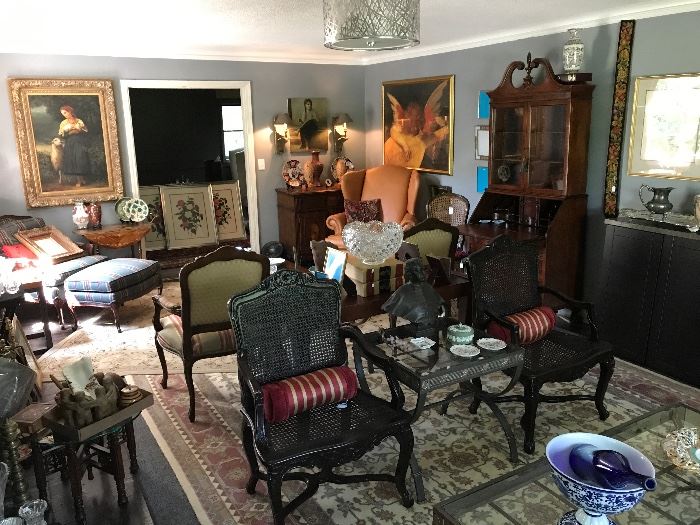 Living room of home filled with antiques and fine decorative items.