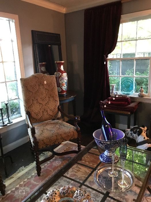 One of a pair of Spanish throne chairs covered and damask velvet and folded and hanging drapery panels in the back of picture plus other vintage textiles 