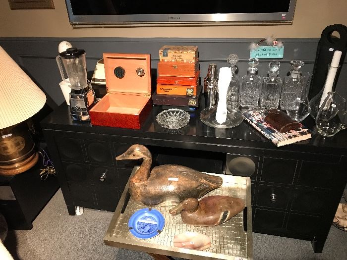 A gentleman's bar with vintage bar  appliances, crystal decanters, humidor, cigar boxes, crystal ashtrays, and other bar pieces 