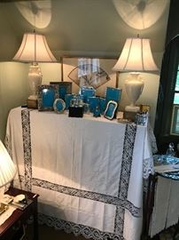  A linen covered Cabinet holding silver frames.