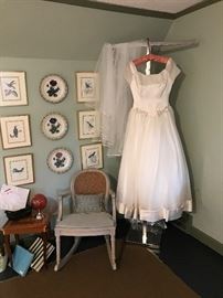 A corner of this bedroom with  assesories wedding gown and a small rocker that is part of the bedroom set.