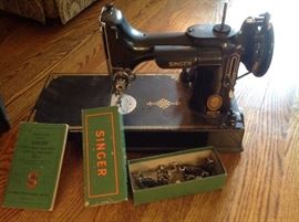 Feather weight singer sewing machine with case, additional parts, the original direction booklet and foot control.  $250....presale available