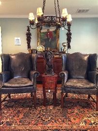 Distressed Navy Leather arm chairs with nailhead details.