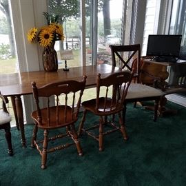 Drop leaf maple pembroke-style table, chairs, flat screen TV in the corner on two pedestals  (one on top of the other)