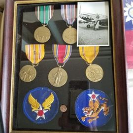 Flying Tigers patch, medals, & a small original photo of Chet Luders sitting on the wing of a flying tiger aircraft