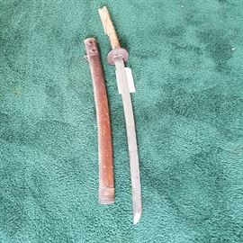 Asian origin sword and sheath.  Handle in as-found condition.  This is NOT part of the military service lot of items, and is priced separately, as are the other knives, swords, etc.