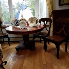 Round pineapple base dining table with 3 chairs, and one wide leaf