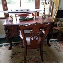 Desk with lion carved corners.  Matching chair in need of reupholstering on the seat.  Chinese rug