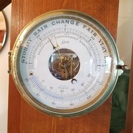 Close up of Schatz barometer with curved thermometer below the central opening