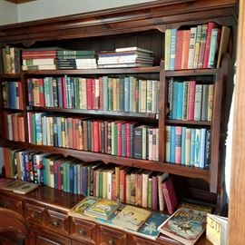 Books in a pine hutch that is also for sale